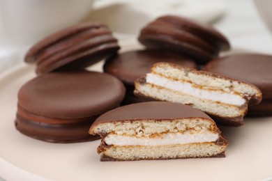 Heap of delicious choco pies on plate, closeup