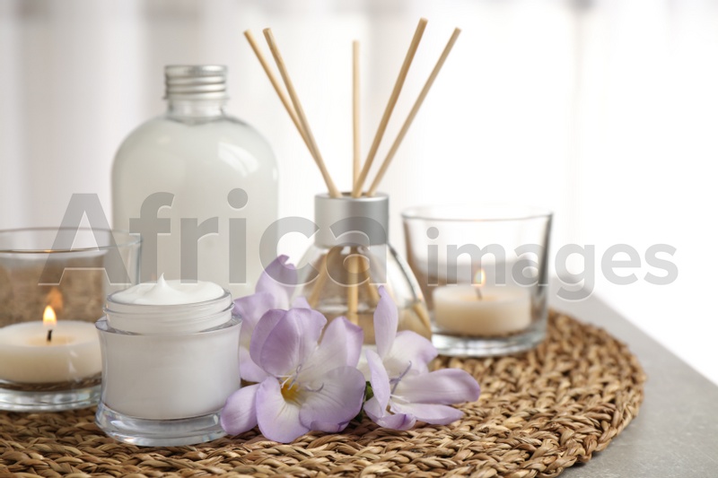 Composition with skin care products and reed air freshener on light background