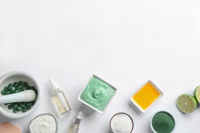 Photo of Composition with spirulina facial mask and ingredients on white background, top view