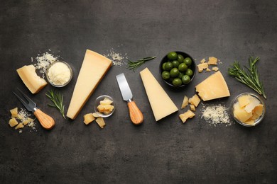Flat lay composition with delicious Parmesan cheese on dark grey table