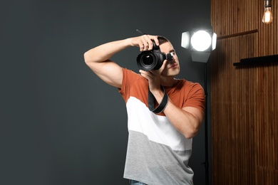 Photo of Professional photographer taking picture in modern studio