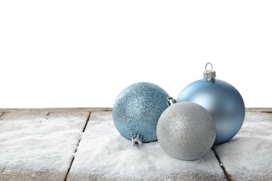 Christmas decoration and snow on table against white background