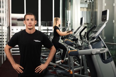 Portrait of personal trainer in modern gym