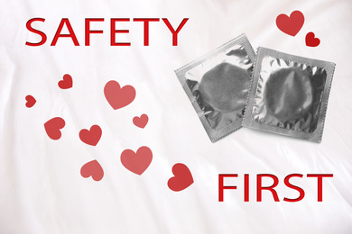 Safety first. Silver condom packages on color background, top view 
