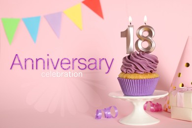Delicious cupcake with number shaped candles on pink background. Coming of age party - 18th birthday. Anniversary celebration