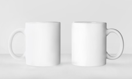 Blank ceramic mugs on white background. Mockup for design
