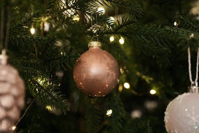 Beautiful baubles and fairy lights on Christmas tree, closeup