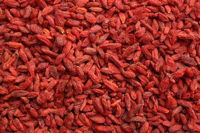 Many dried goji berries as background, top view. Healthy superfood