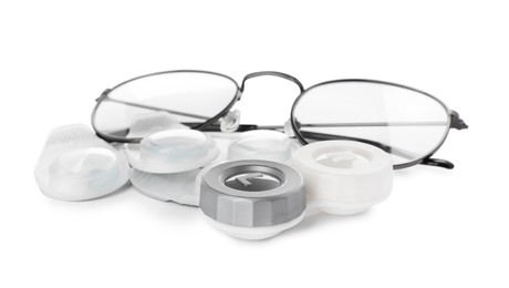 Packages with contact lenses, case and glasses on white background