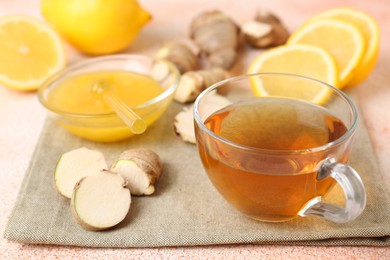 Photo of Tea, honey, lemon and ginger on table, closeup