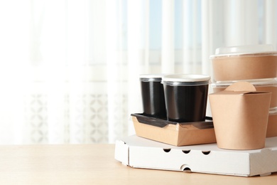 Various takeout containers on table, space for text. Food delivery service