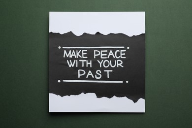 Photo of Card with life-affirming phrase Make Peace With Your Past on dark green background