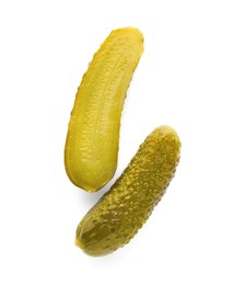 Tasty cut and whole pickled cucumbers on white background, top view