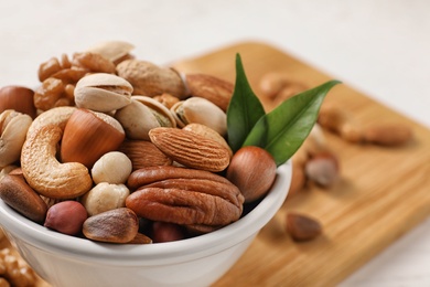 Photo of Bowl with organic mixed nuts on table, closeup