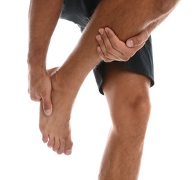 Man suffering from foot pain on white background, closeup