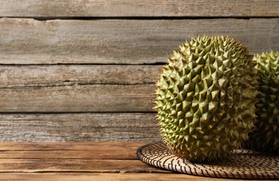 Ripe durians on wooden table. Space for text
