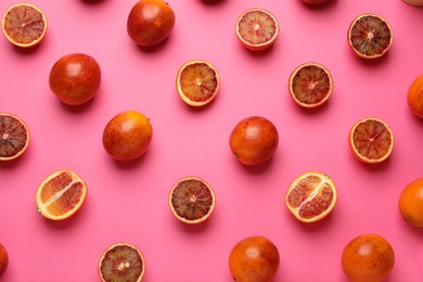 Many ripe sicilian oranges on pink background, flat lay