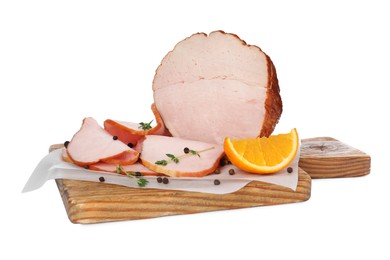 Delicious cut ham with thyme, orange slice and peppercorns isolated on white