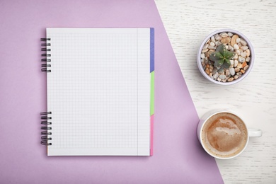 Flat lay composition with notebook and cup of aromatic coffee on color background