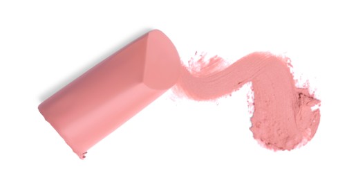 Photo of Nude color lipstick and smear on white background, top view