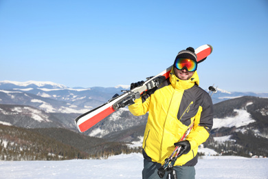 Young man with ski on hill. Winter vacation