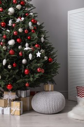 Beautifully decorated Christmas tree and many gift boxes in room