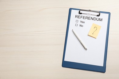 Referendum ballot with clipboard and pen on white wooden table, flat lay. Space for text