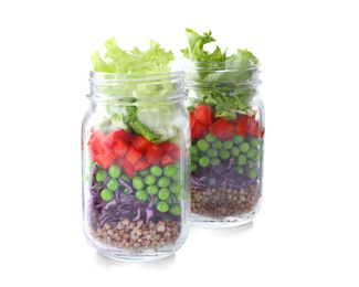 Healthy salad in glass jars isolated on white