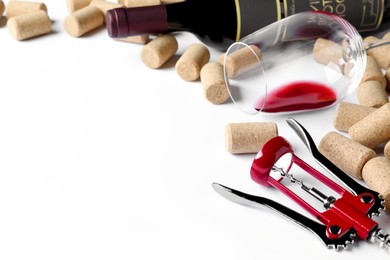 Photo of Corkscrew with wine bottle, glass and stoppers on white background