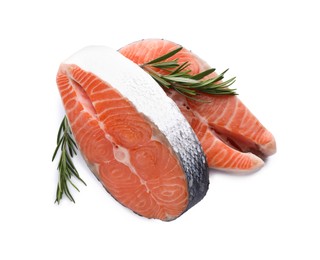 Fresh raw salmon steaks with rosemary on white background, top view
