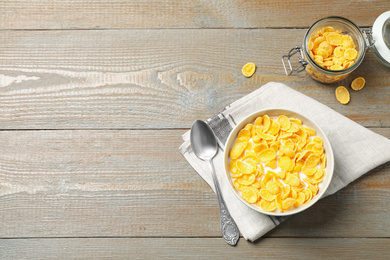 Photo of Flat lay composition with tasty corn flakes on wooden table, space for text