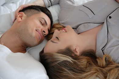 Lovely couple enjoying time together on bed