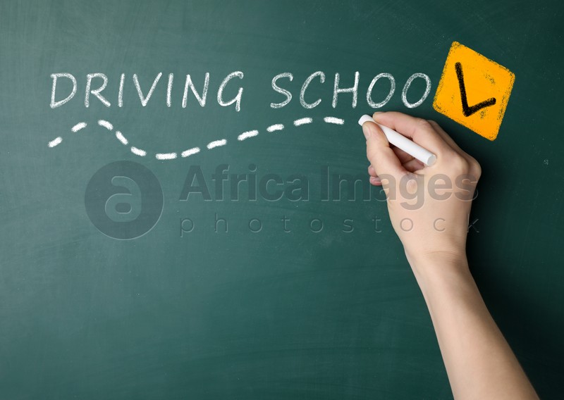  Driving school concept. Woman with white chalk near green board, closeup