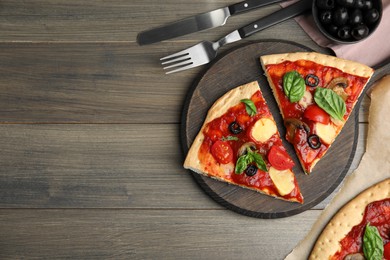 Slices of delicious pita pizza on wooden table, flat lay. Space for text