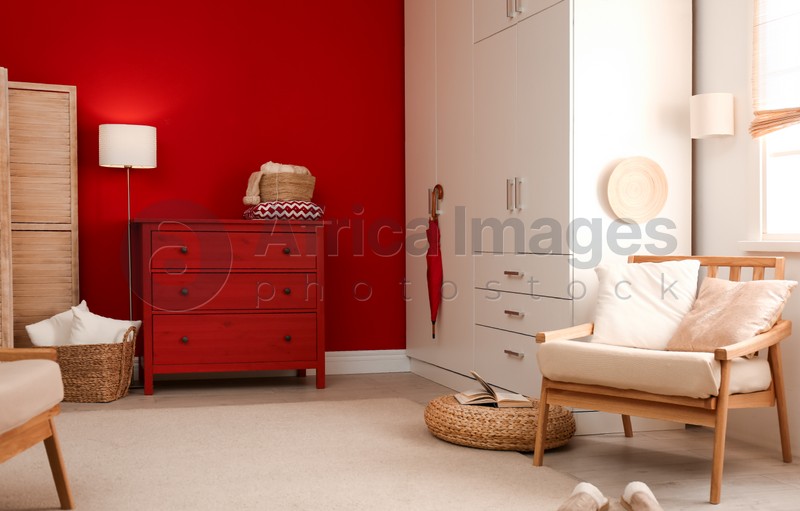 Modern room interior with red chest of drawers
