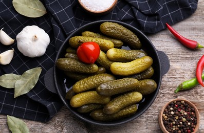 Photo of Pickled cucumbers and ingredients on wooden table, flat lay