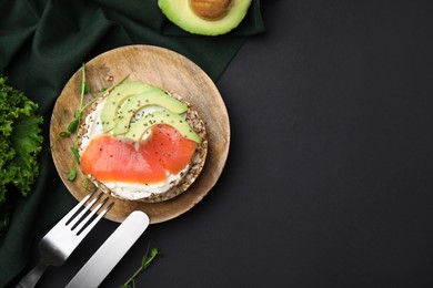 Crunchy buckwheat cakes served with cream cheese, salmon and avocado on table, flat lay. Space for text