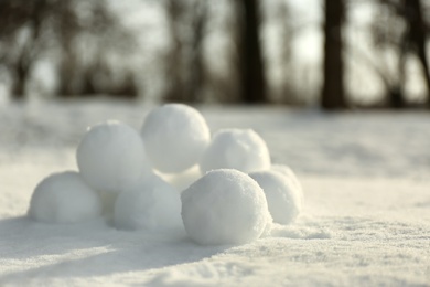 Photo of Perfect round snowballs on snow outdoors, closeup