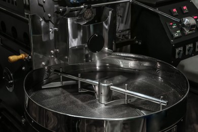 Stainless coffee roaster machine indoors. Modern device