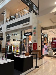 Photo of Poland, Warsaw - July 12, 2022: Official Inglot and Kodano Optyk stores in shopping mall