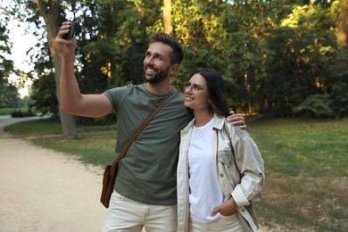 Photo of Lovely couple taking selfie together in nature reserve