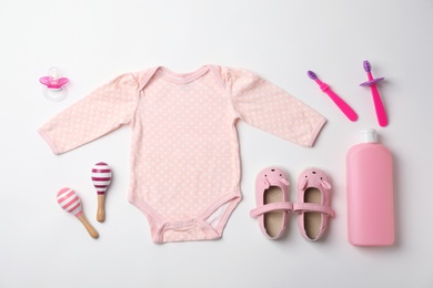 Flat lay composition with baby clothes and accessories on white background