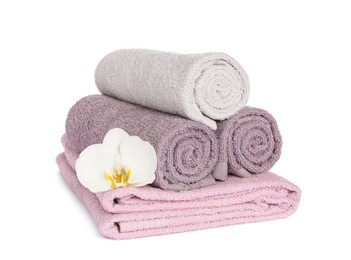 Clean soft towels with orchid isolated on white