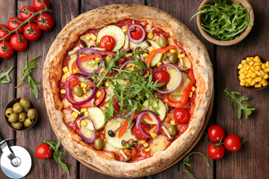 Photo of Flat lay composition with vegetable pizza on wooden table