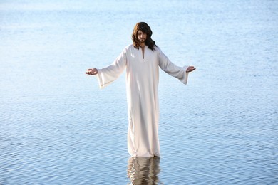 Jesus Christ in water lit by morning sun