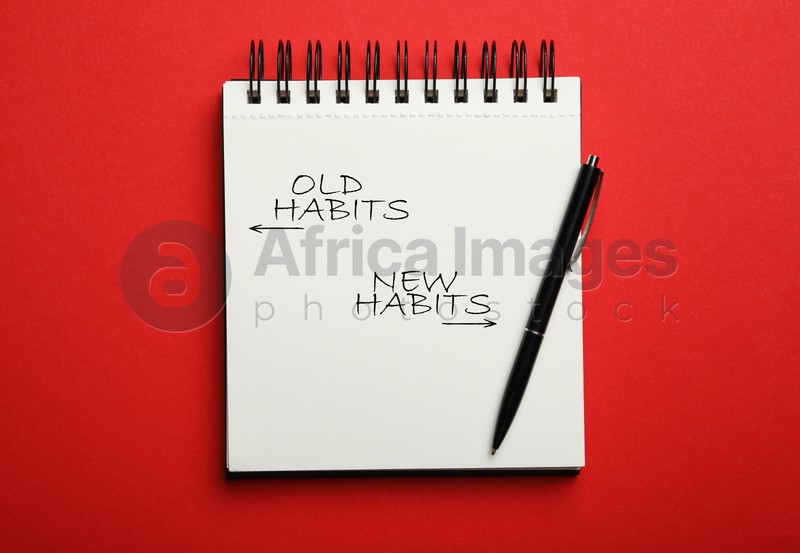 Notebook with two opposite directions to Old and New Habits on red background, top view