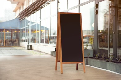 Empty A-board near building outdoors. Mockup for design