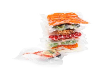 Vacuum packs with different food products on white background