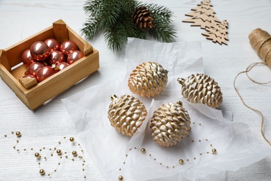 Composition with beautiful Christmas baubles on white wooden table