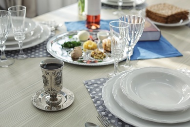 Antique goblet and plates on table served for Passover (Pesach) Seder